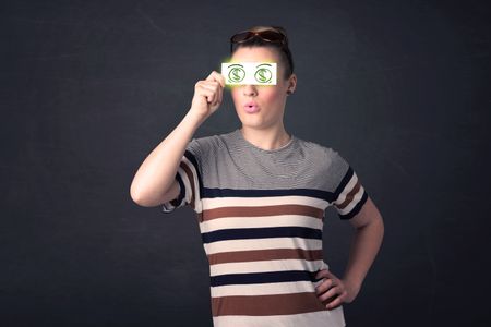 Young girl holding paper with green dollar sign concept