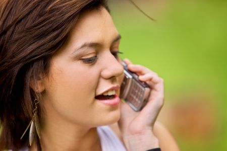 Woman talking on her mobile phone outdoors