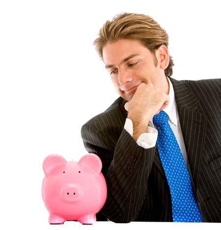 Business man staring at a piggy bank isolated