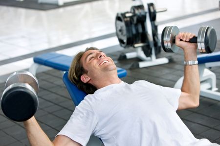 man lifting free weights at the gym