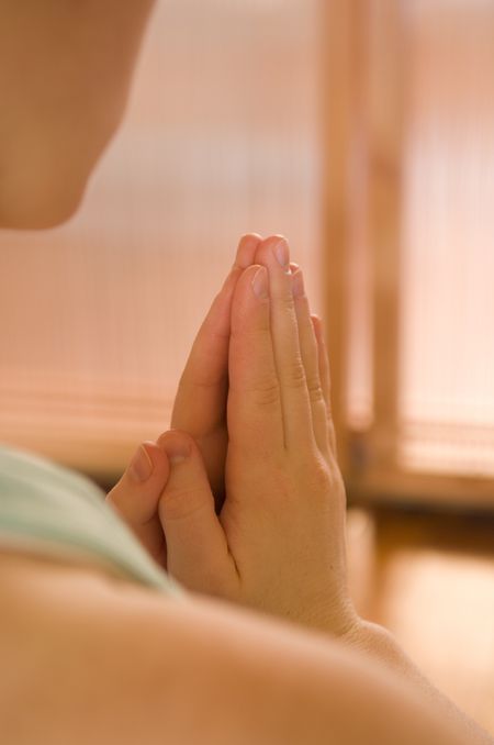 close up of hands in prayer in yoga
