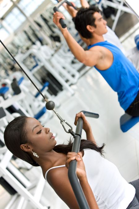 Group of people exercising with the machines at the gym