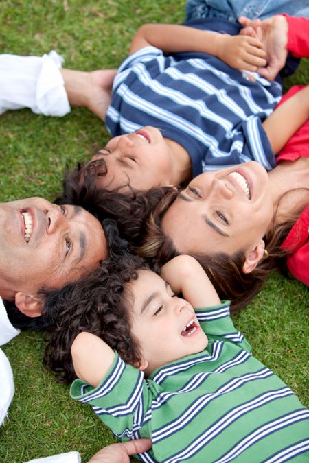 Happy family wih their heads together on the floor