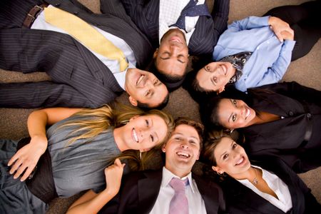 Business group in an office with heads together on the floor