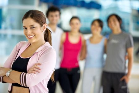 Beautiful woman at the gym and people behind