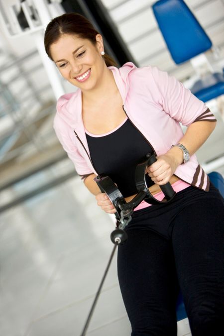 Happy woman exercising at the gym