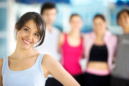 Portrait of a woman at the gym in front of a group
