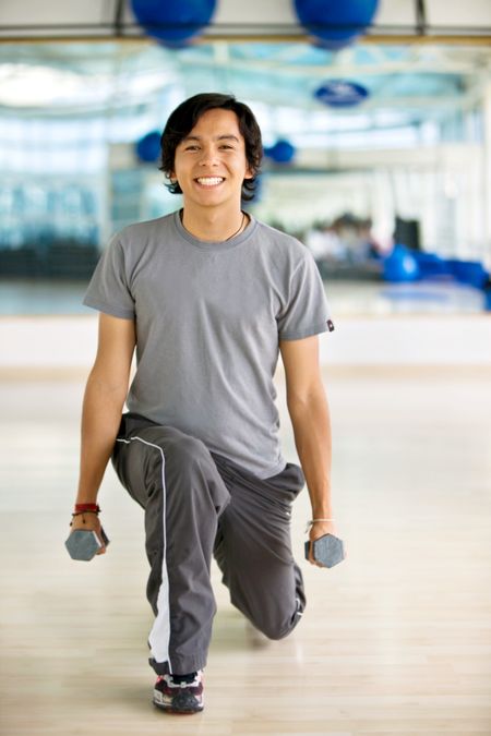 man lifting free weights at the gym
