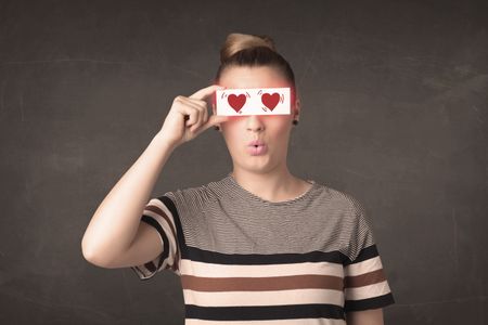 pretty-girl-holding-paper-red-heart-274578602 Pretty girl holding paper with red heart drawing concept