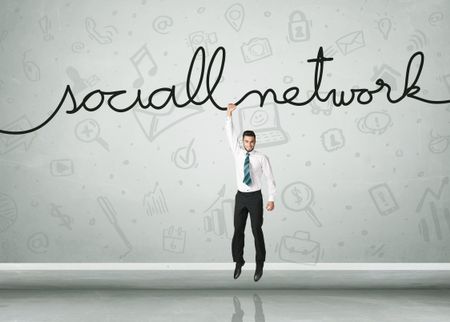 Businessman hanging on a social network rope 
