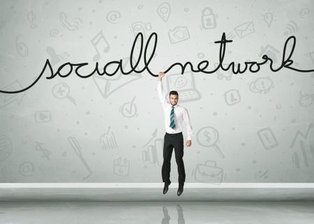 Businessman hanging on a social network rope