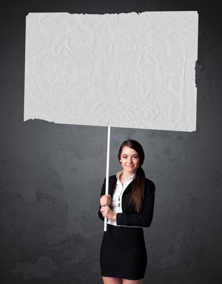 Young businesswoman holding a big blank booklet paper 