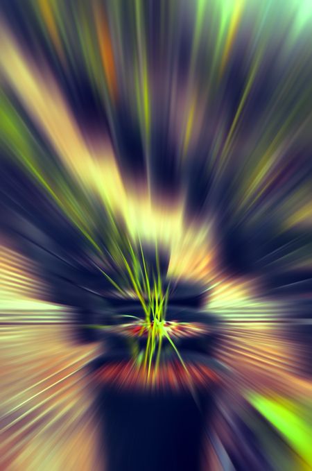 Surreal abstract of radially blurred leafy plants in planters in a production greenhouse, with multicolored aura of emanation for themes of growth, potential, or release of energy or essence