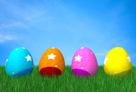 colorful easter eggs on grass in front of a beautiful blue sky