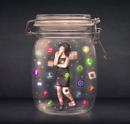 Businesswoman captured in a glass jar with colourful app icons concept on background
