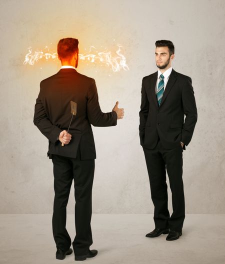 angry-businessman-hiding-weapon-back-278622161 Angry businessman hiding a weapon behind his back