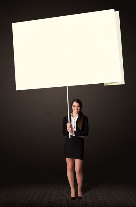 young-businesswoman-holding-big-white-postit-278625626 Young businesswoman holding a big, white post-it paper
