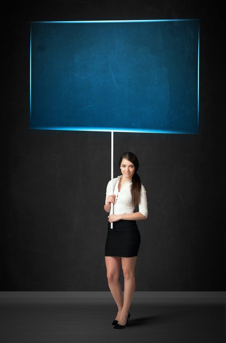 Young businesswoman holding a big, blue board
