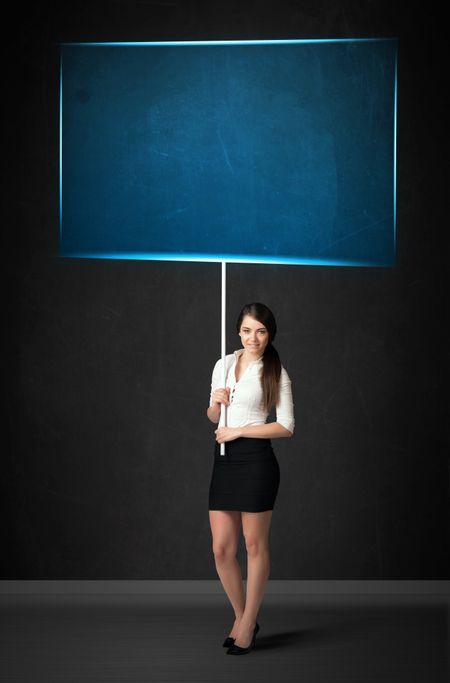 Young businesswoman holding a big, blue board