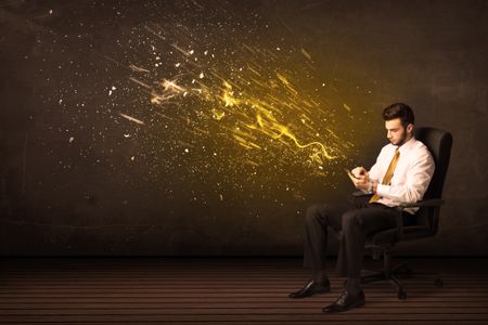 Businessman with tablet and energy explosion on background concept