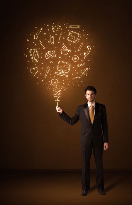 Businessman holding a social media shining balloon on a brown background