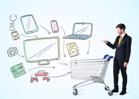 Businessman pushing a shopping cart drawn media devices coming out of it
