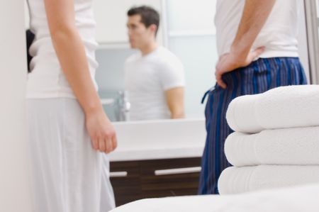 Couple talking in bathroom.