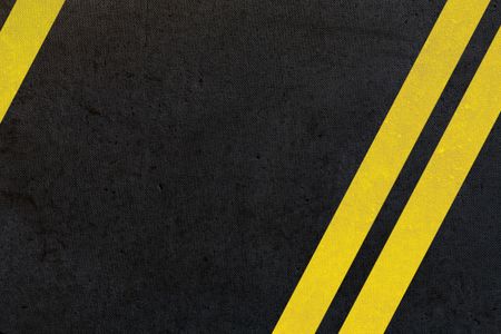asphalt background with double yellow lines on an angle