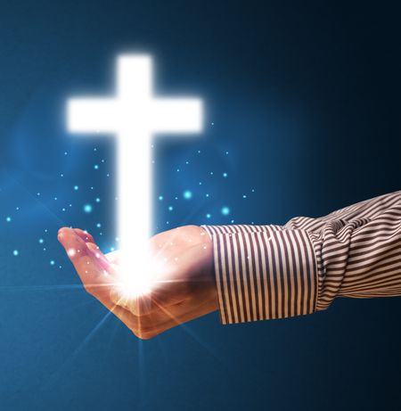 young-businessman-holding-glowing-cross-hand-280667330 Young businessman holding a glowing cross in his hand