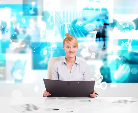 Business person at desk with modern blue tech images at background