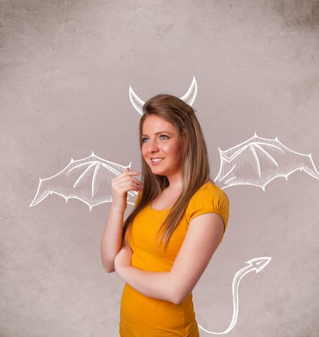 Young nasty girl with devil horns and wings drawing