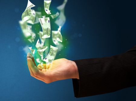 businessman-holding-glowing-paper-moneys-hand-280669538 Businessman holding glowing paper moneys in his hand
