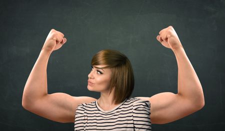 Pretty young woman with strong and muscled arms concept