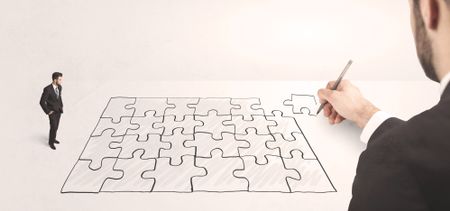 Business man looking at hand drawing solution, puzzle solution concept