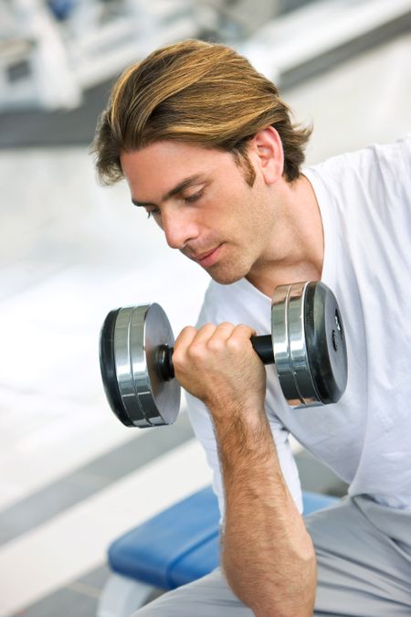 man lifting free weights at the gym