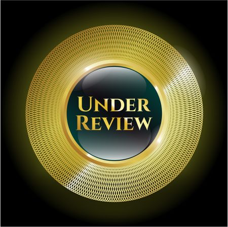 Under review gold shiny badge