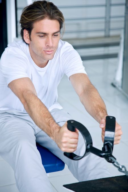 Handsome man exercising at the gym