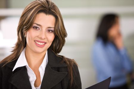 Business woman portrait in an office smiling