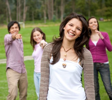happy group of friends smiling outdoors in a park