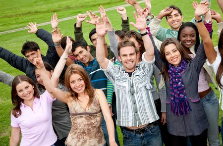 Group of friends with their hands in the air