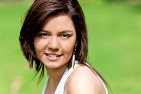 casual girl smiling outdoors in a park