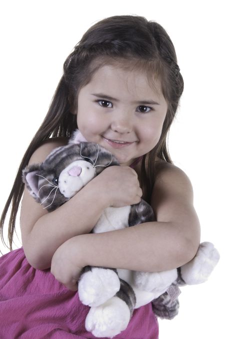 Portrait of happy girl of five hugging teddy bear