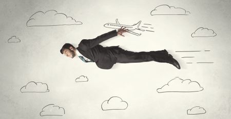Cheerful business person flying between hand drawn sky clouds concept on background