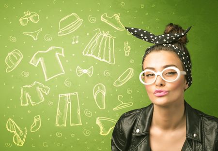 Happy young woman with glasses and casual clothes icons concept on green background