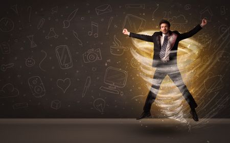 Happy businessman jumping in tornado concept on brown background