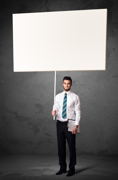Young businessman holding a blank whiteboard