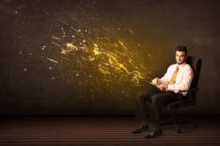 Businessman with tablet and energy explosion on background concept