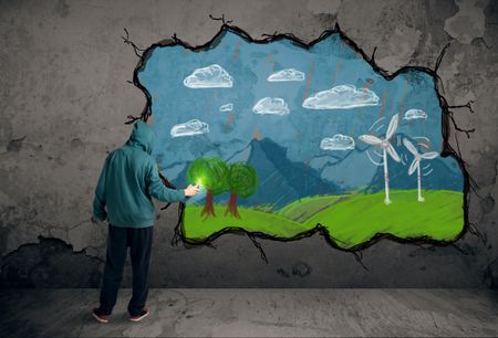 Young urban painter drawing colorful future image on the wall