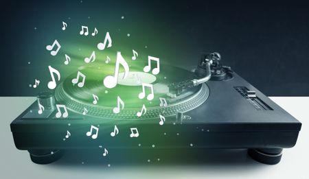 Turntable playing music with audio notes glowing concept on background