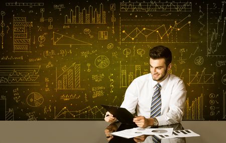 Businessman sitting at black table with hand drawn diagram background
